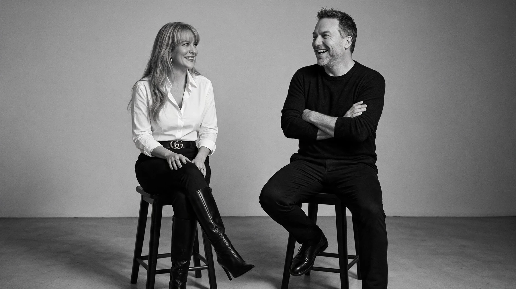 Summer and Randy Branam seated on studio stools, smiling and laughing together